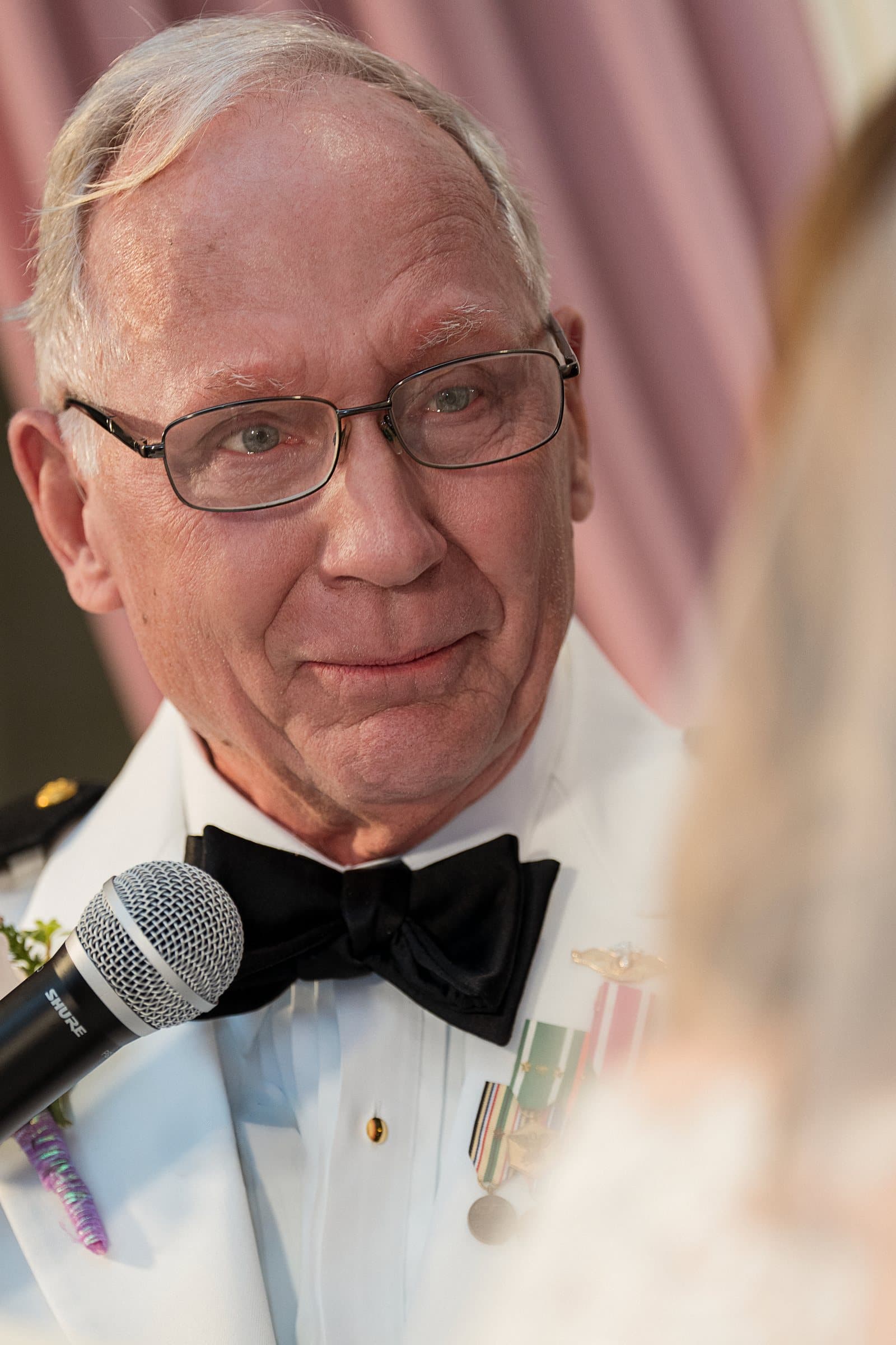 Robert at the microphone, a tear as he speaks his vows