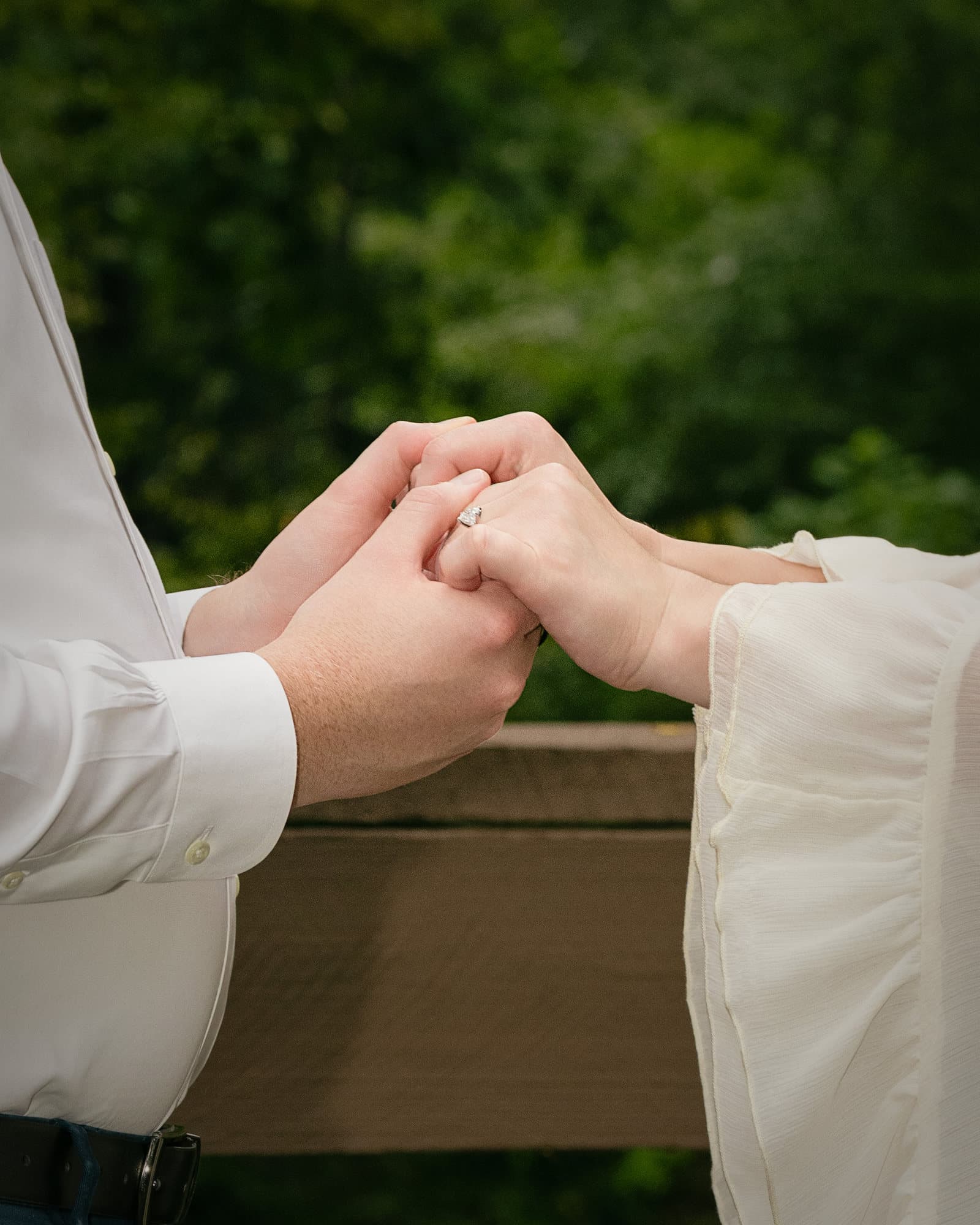 Hands joined on the wooden rail