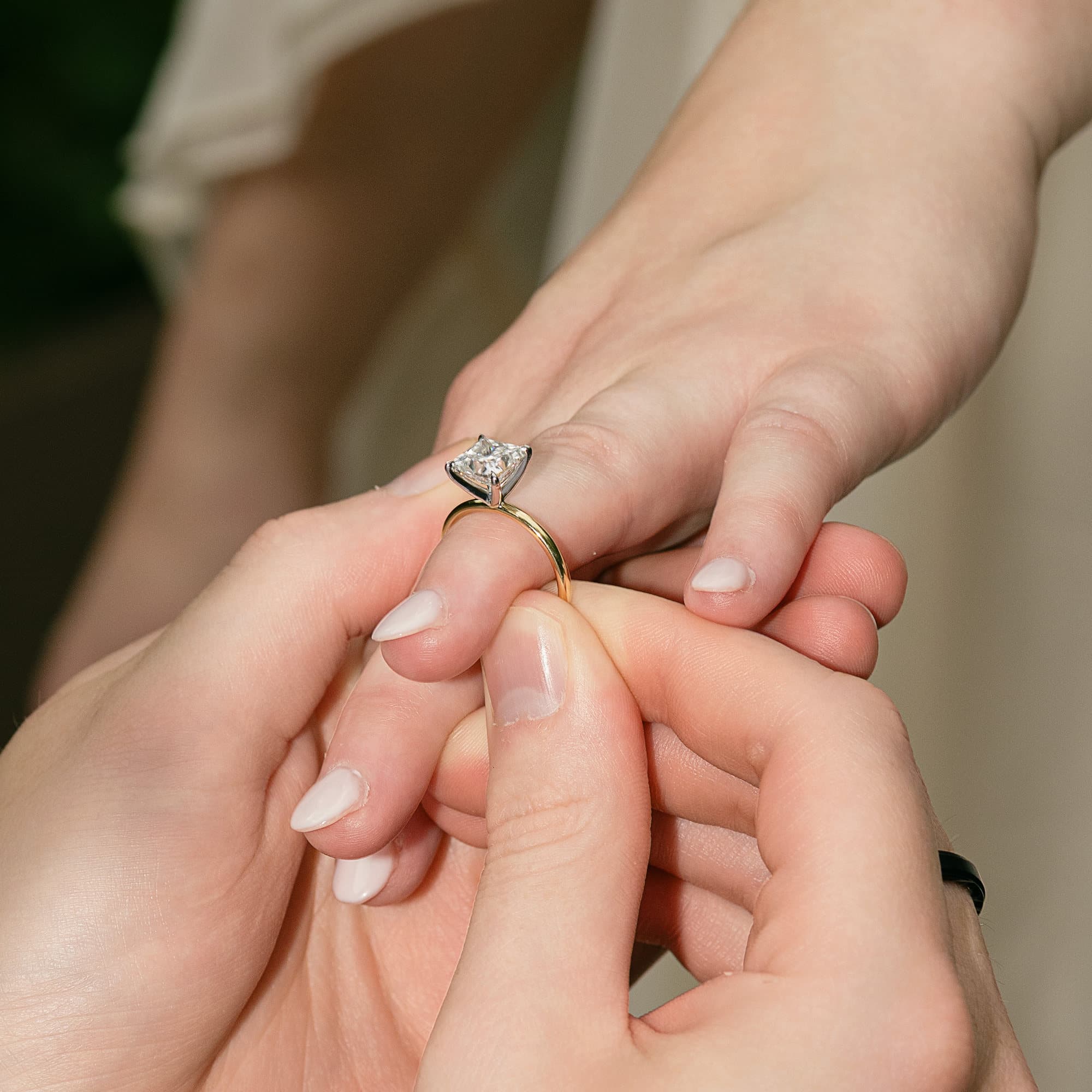 The ring sliding onto Sarah's finger, macro