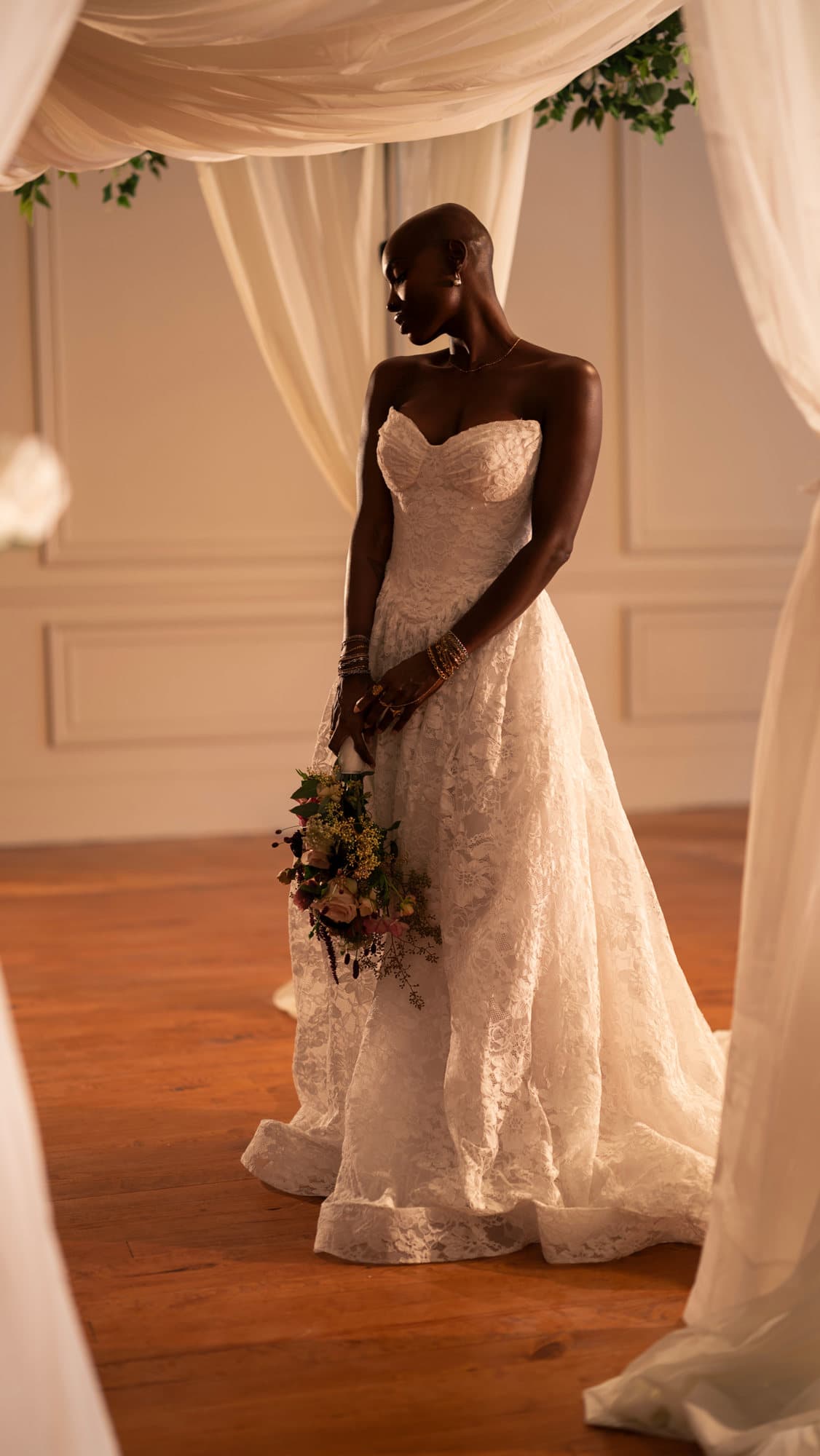 Bride standing in the ivory drape corridor