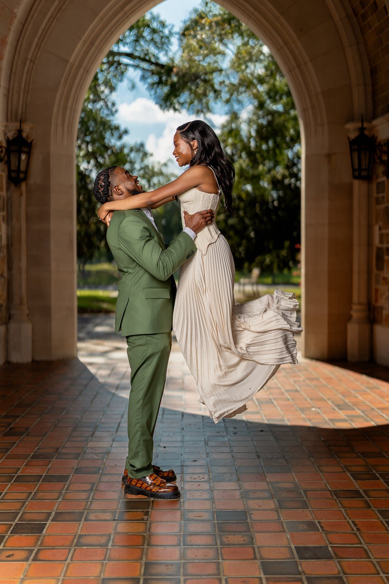 The bride lifted in her groom's arms