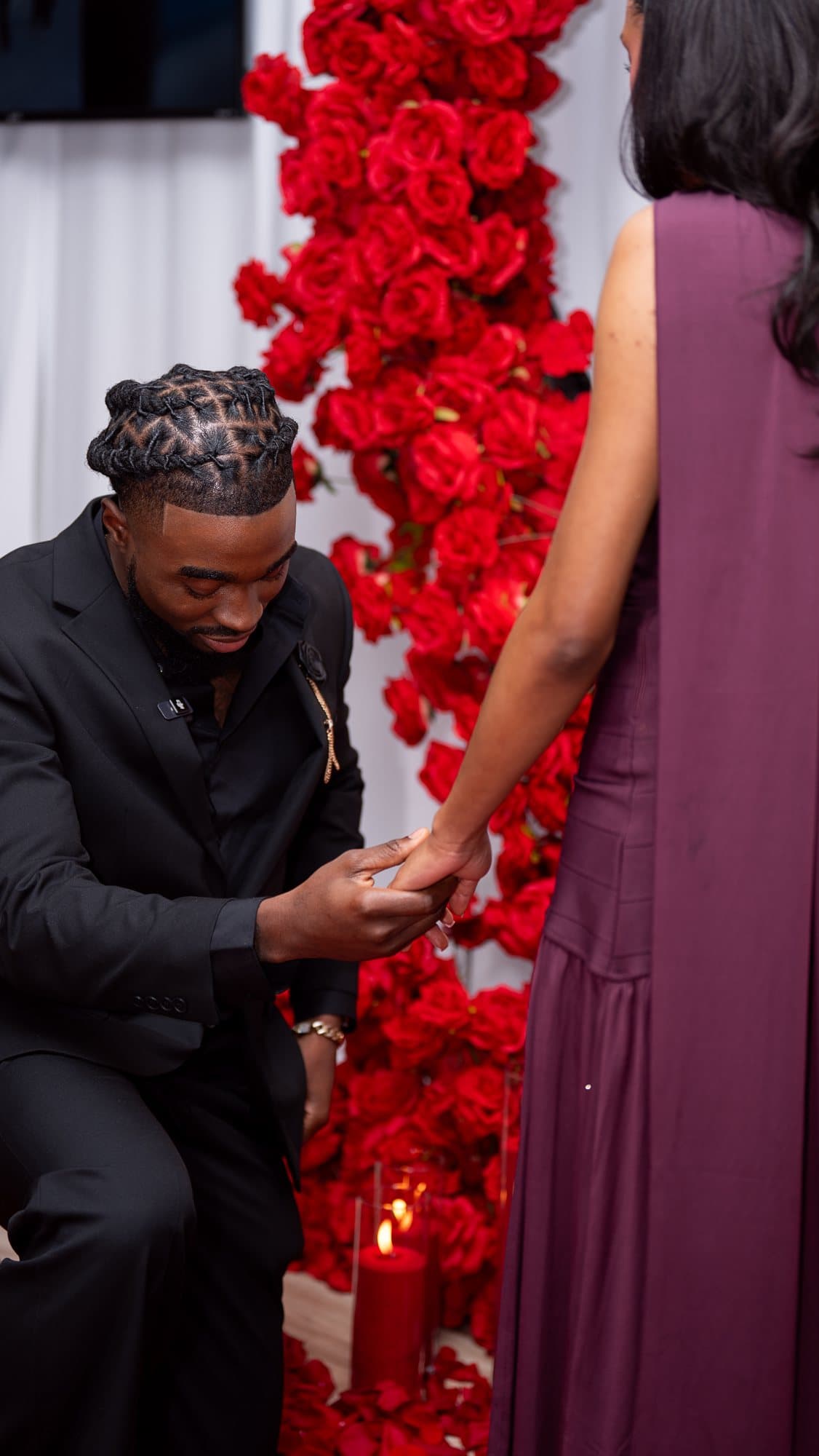 The proposal in front of the red rose wall