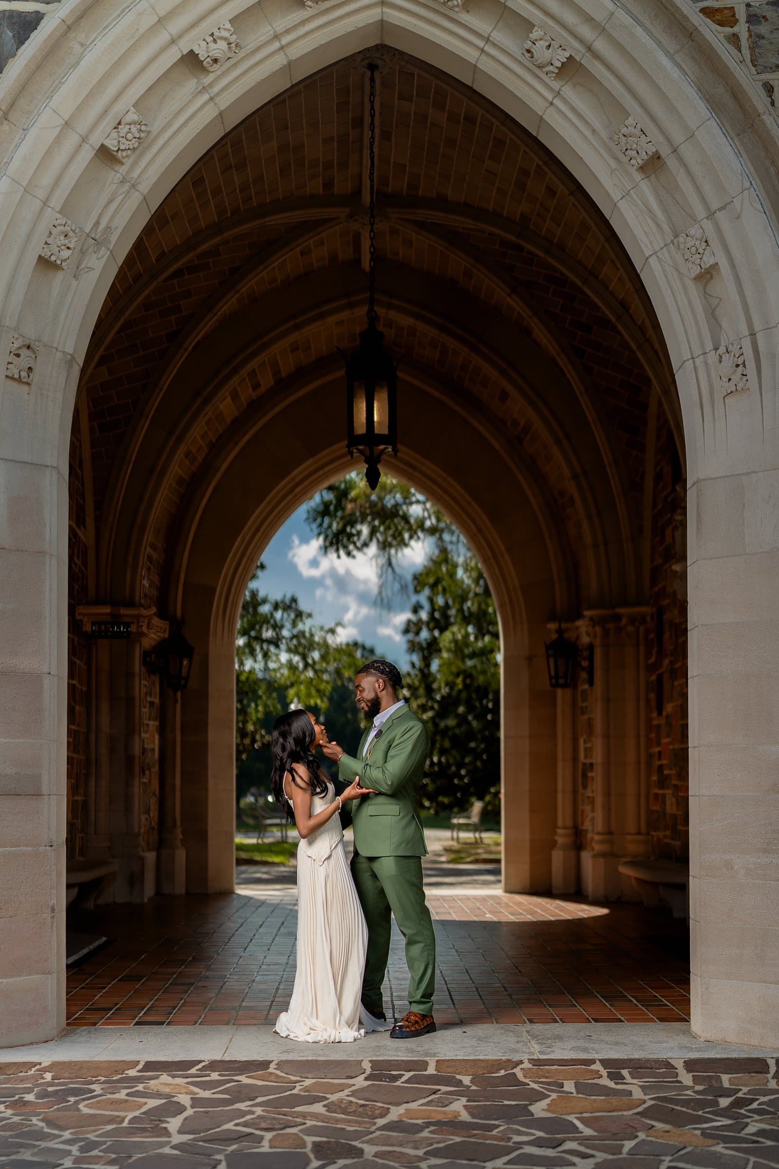 The couple beneath a stone arch