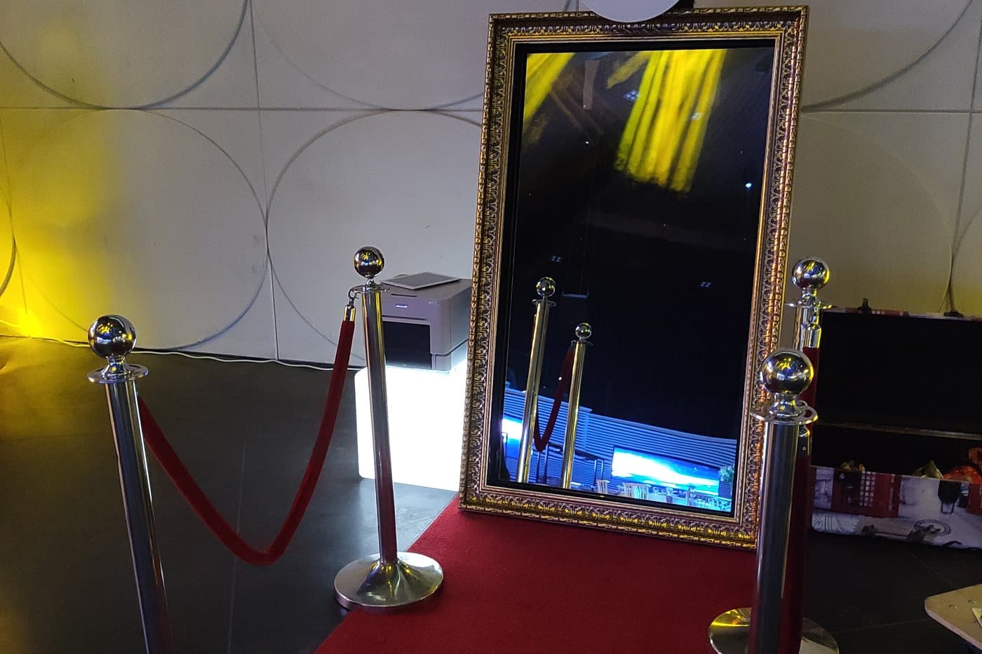 The mirror booth on a red carpet behind velvet rope stanchions