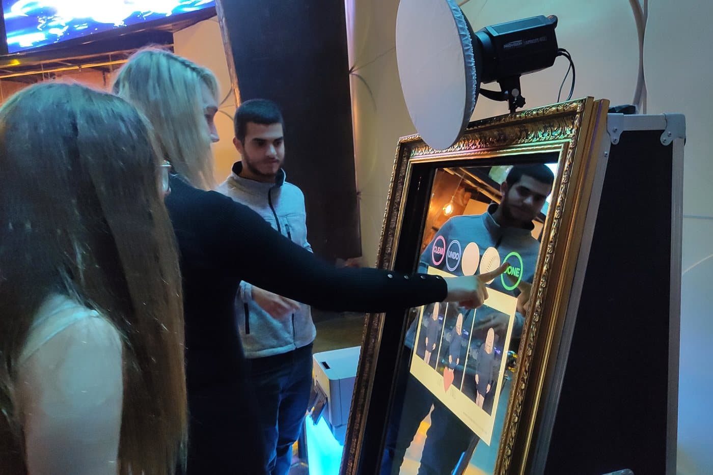 Guests interacting with the mirror booth at a brand activation
